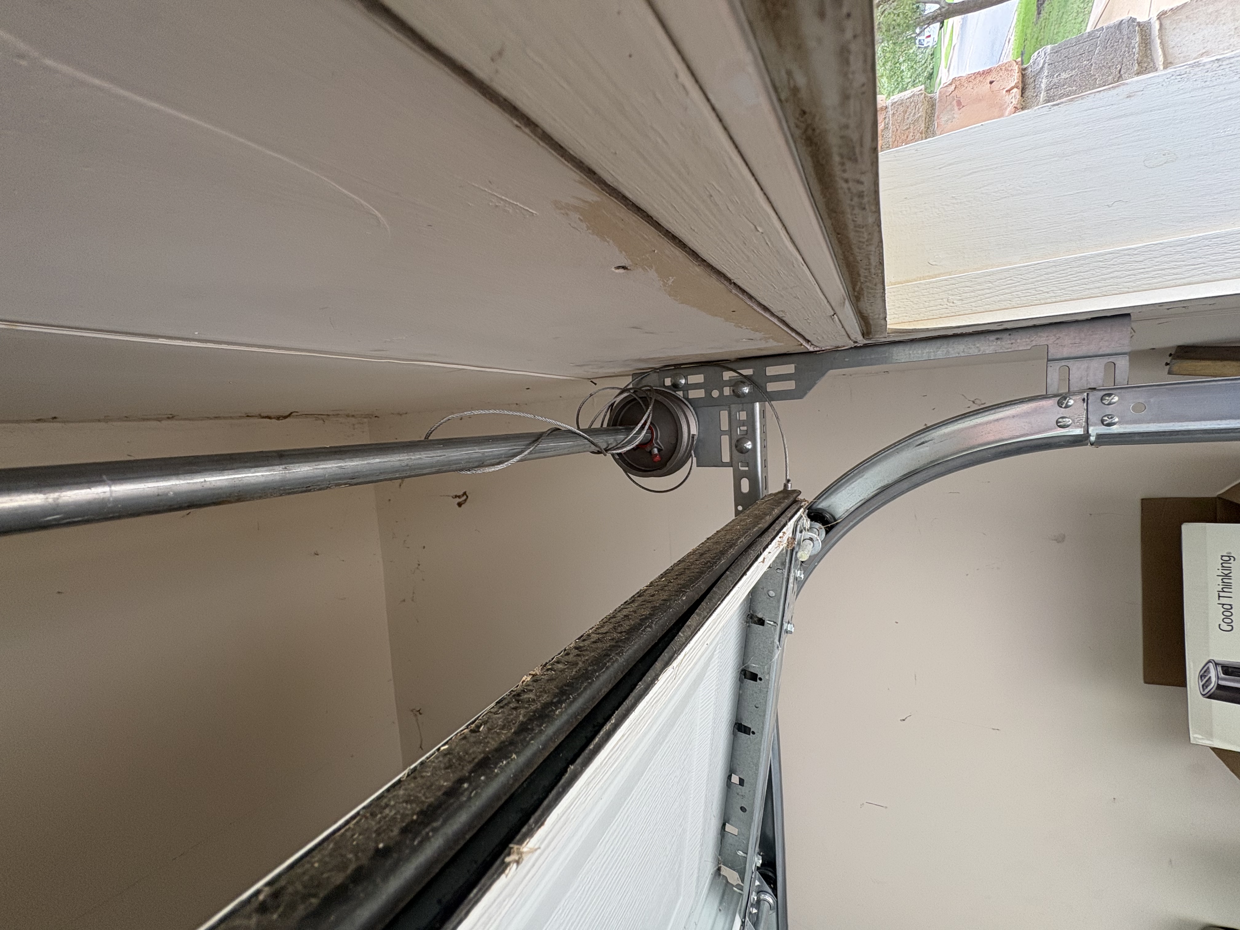Garage door cable off the drum on an Austin TX service call door sitting unevenly