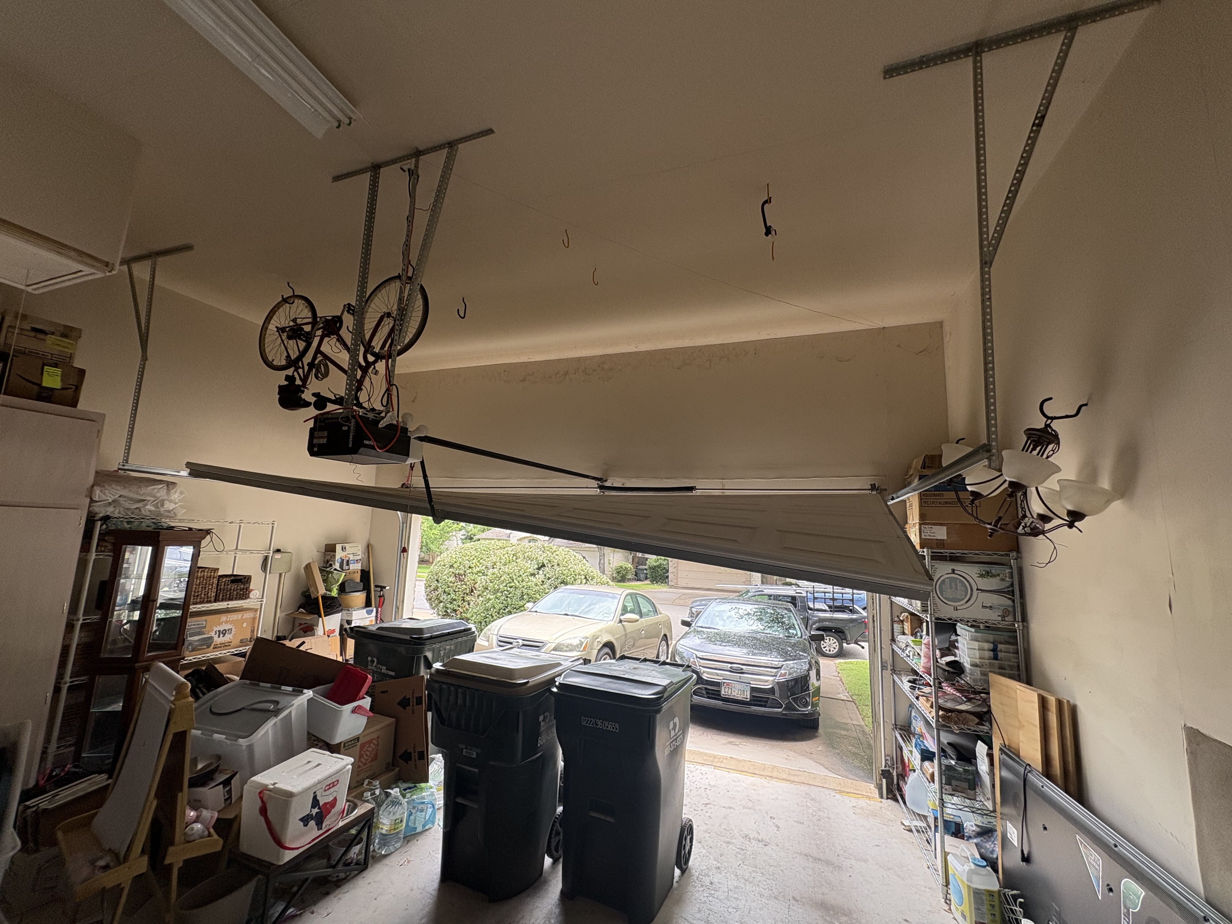 Garage door off track in Austin TX — door panels folded inward