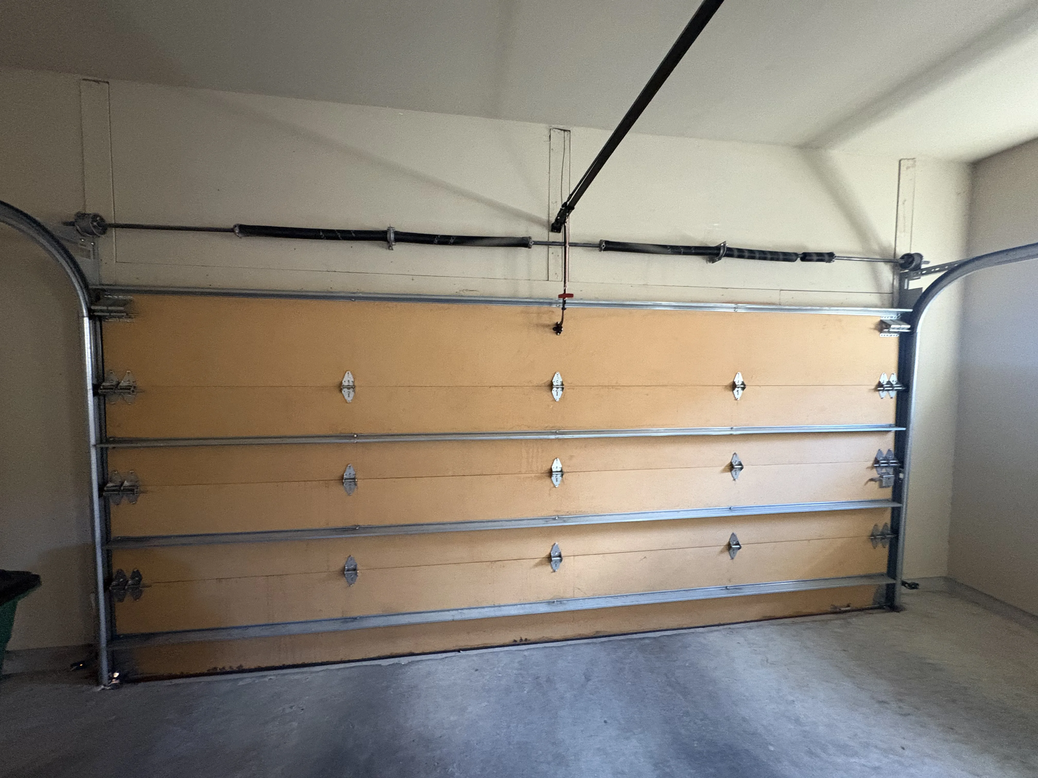 Before - garage door with worn springs Austin TX