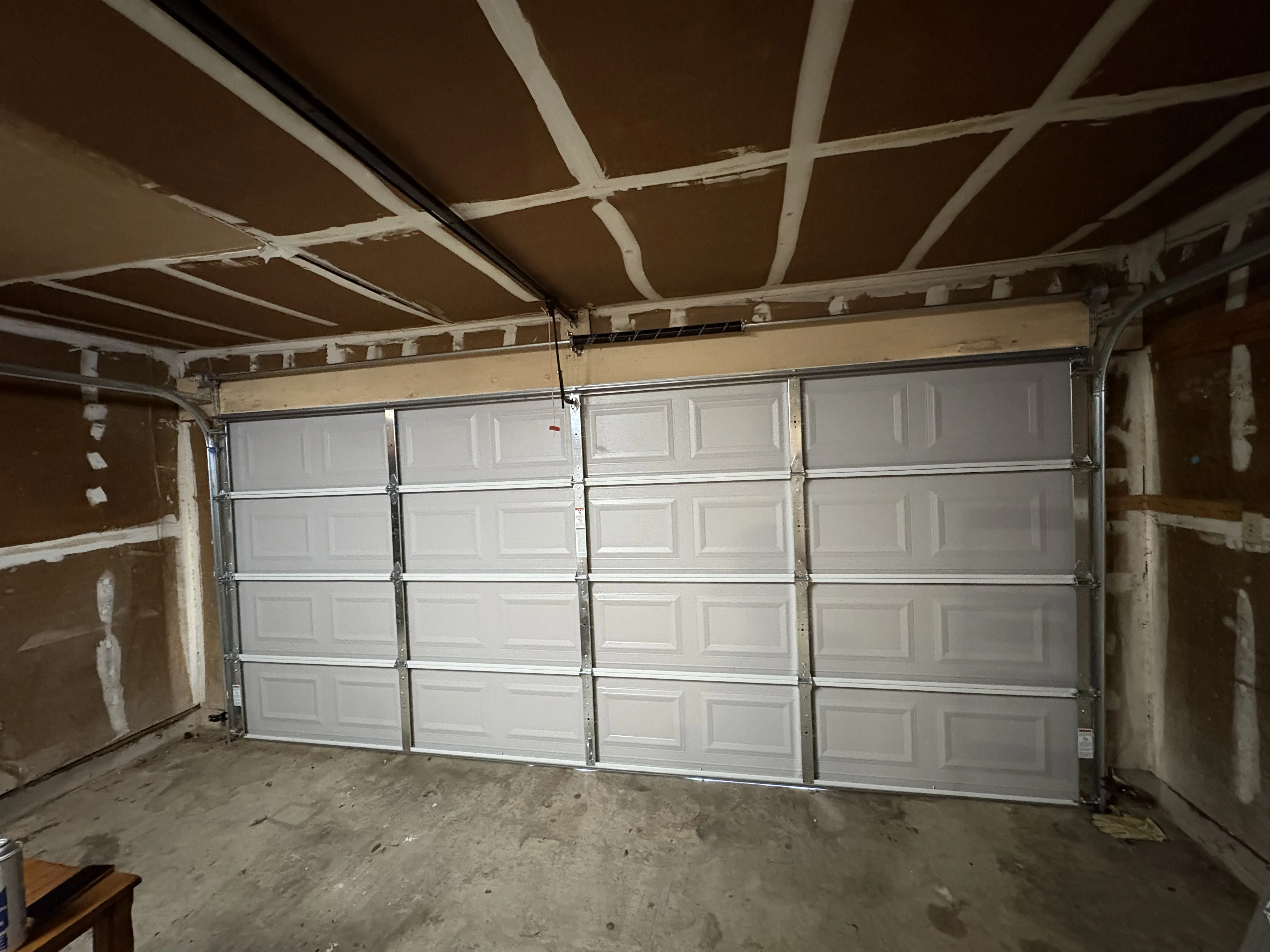 After - new modern garage door installed interior view Austin TX