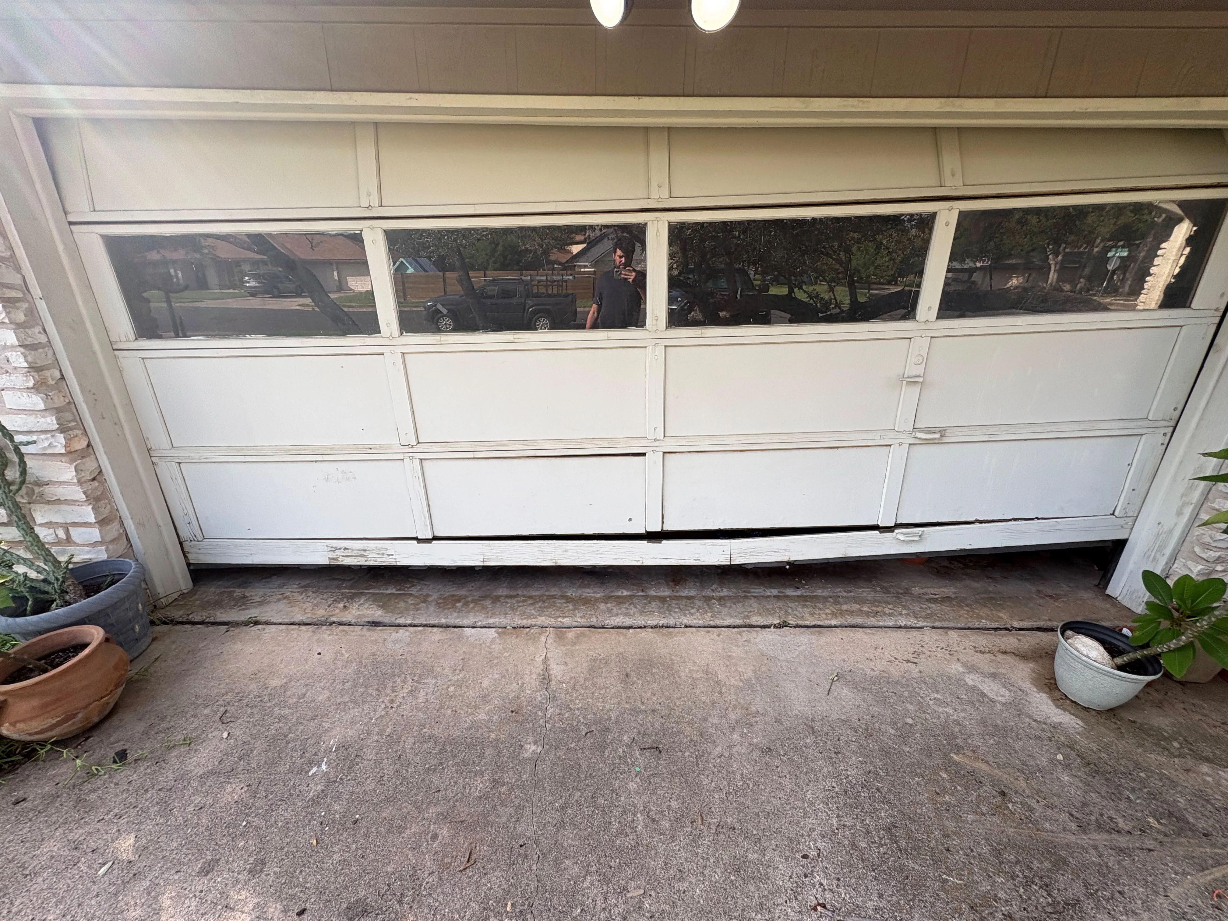 Before - deteriorated wood garage door exterior view