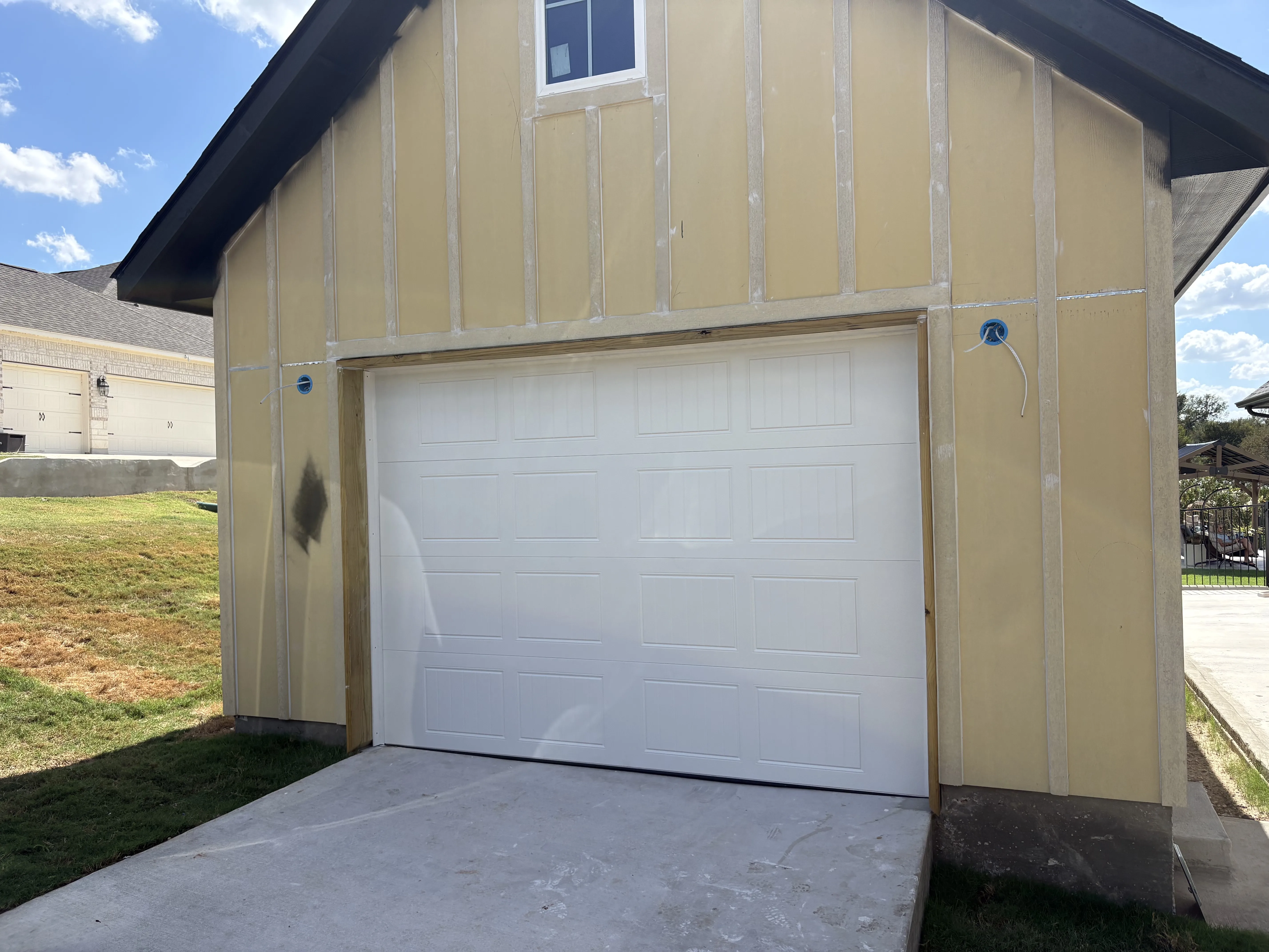After - new 10x7 white carriage style garage door exterior Cedar Creek TX