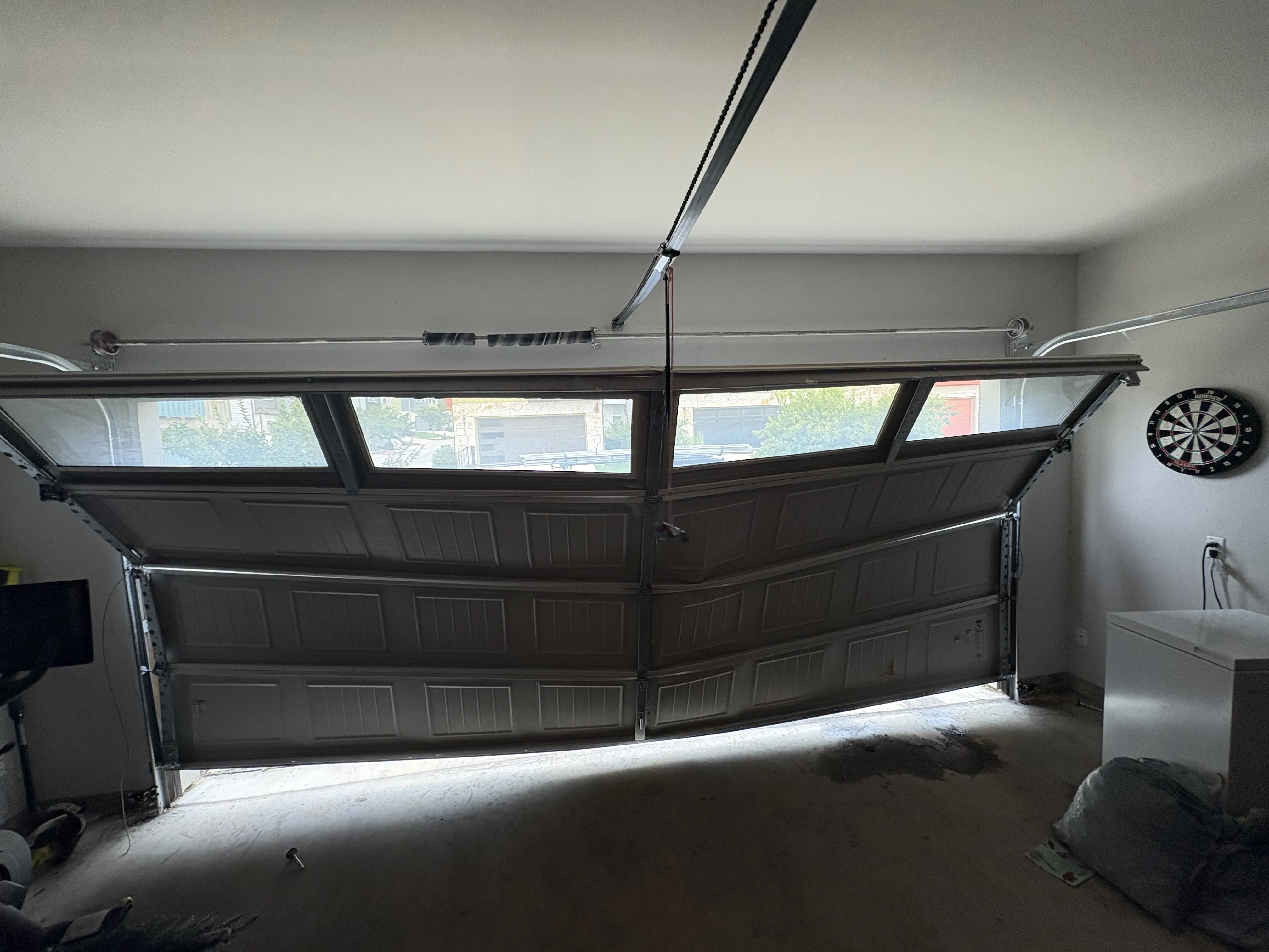 Before - garage door damaged by broken spring malfunction interior view