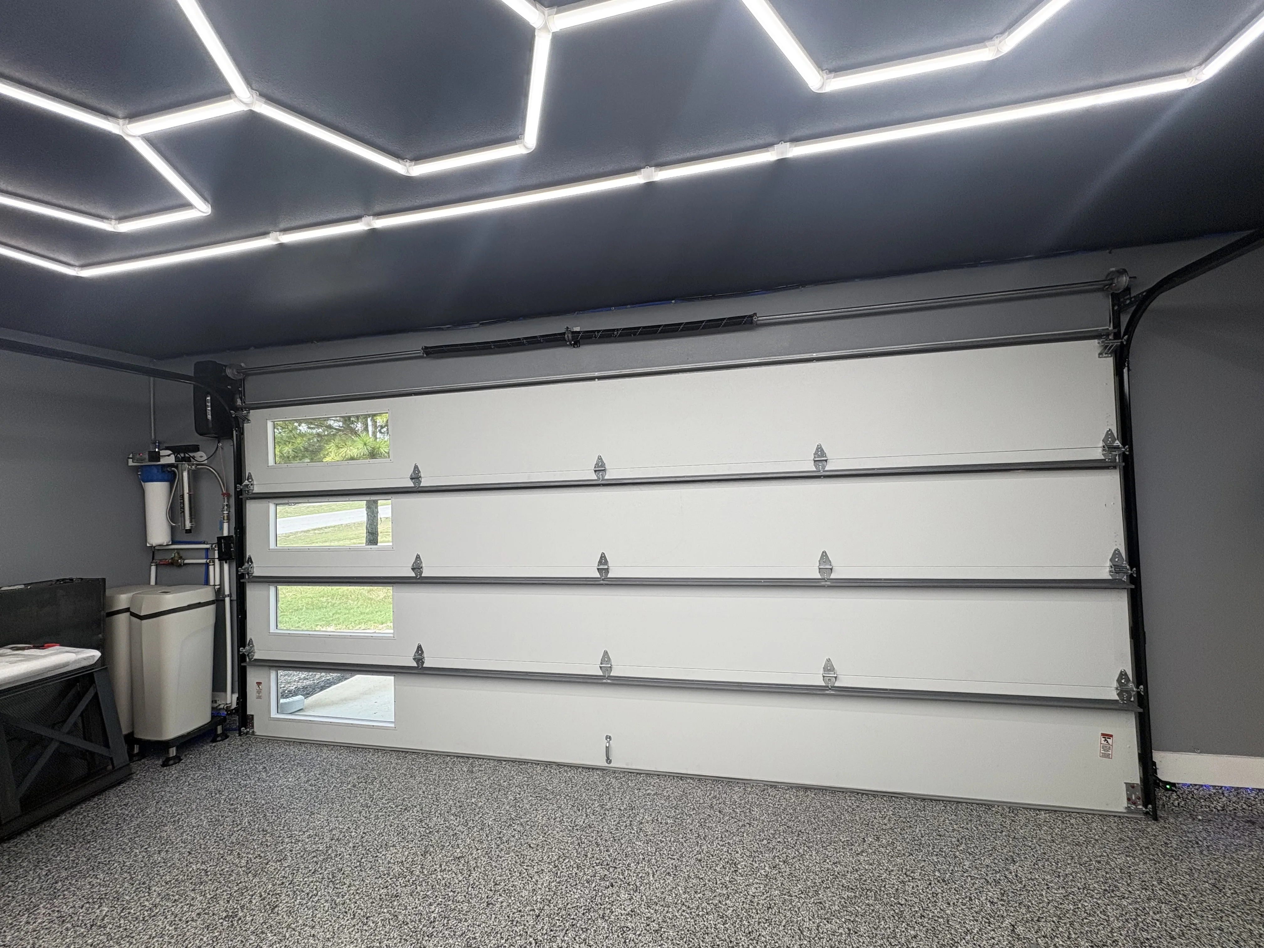 After - new black flush steel insulated garage door interior view