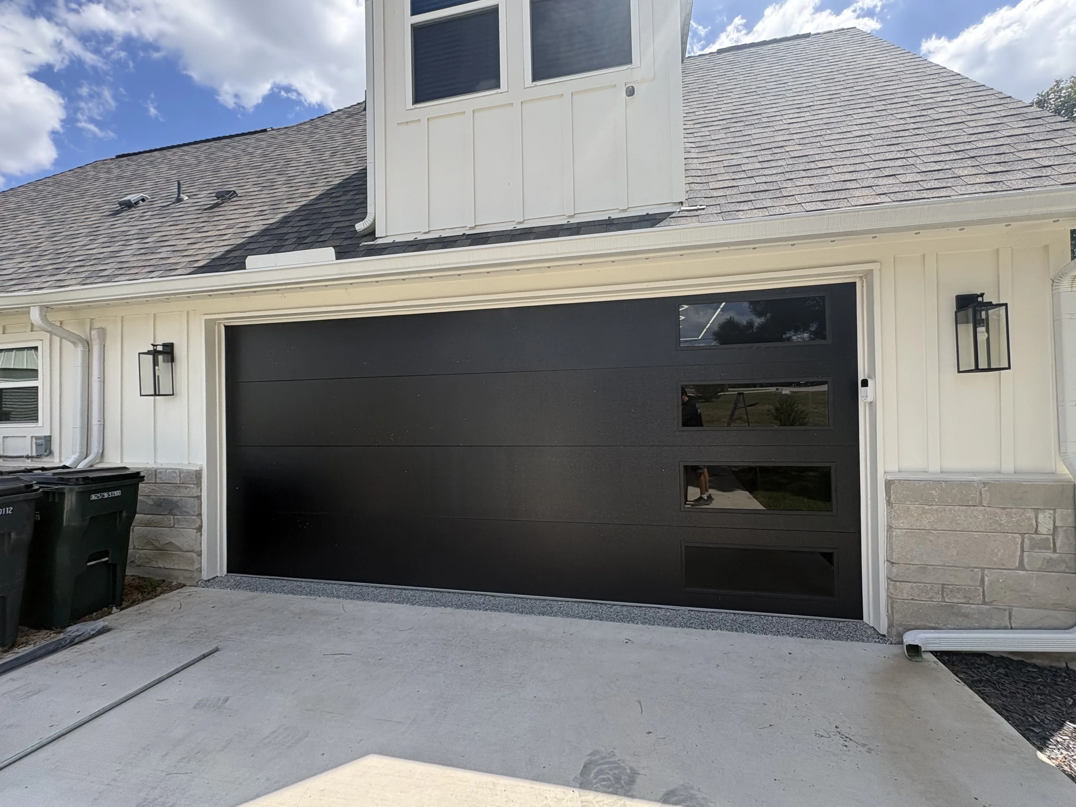After - stunning black flush 18x8 garage door with windows exterior Paige TX